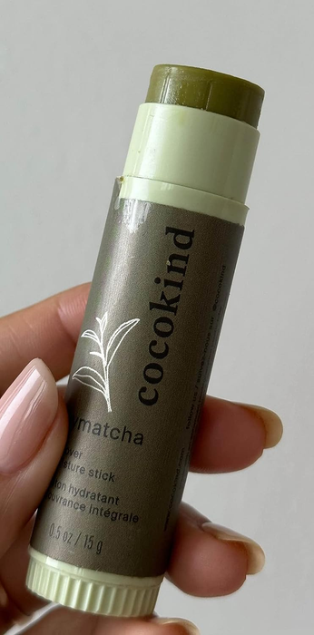 A model is holding the matcha stick.
