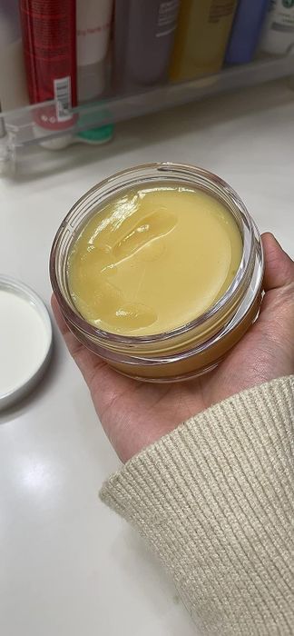 An open jar showcasing the balm.