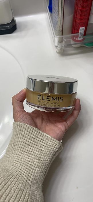 A reviewer holding the cleansing balm.