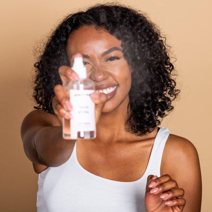 A model is seen holding the spray.