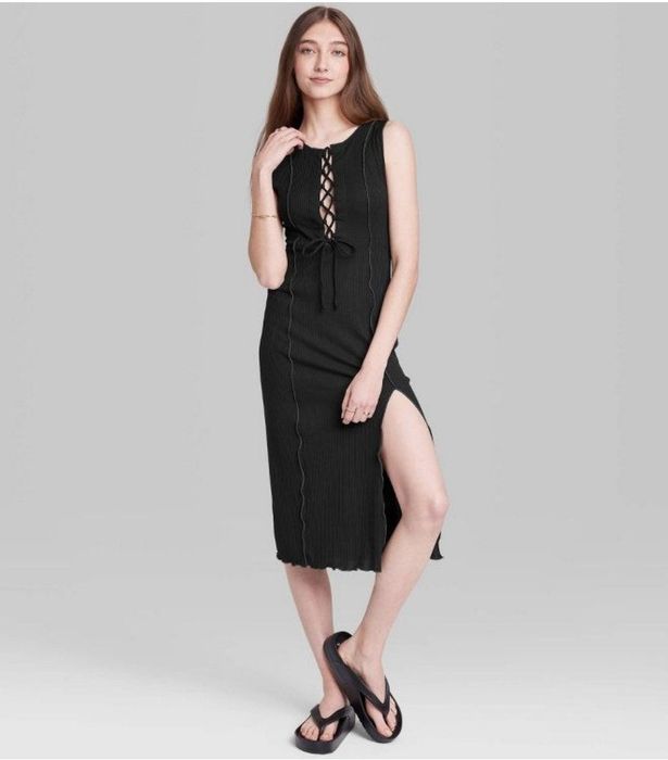 A model is showcasing a black lace-up dress.