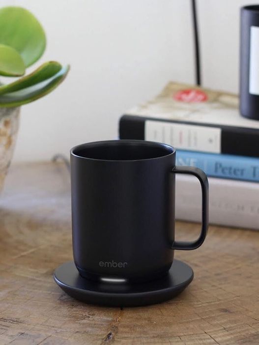 A photo of a black Ember mug filled with coffee