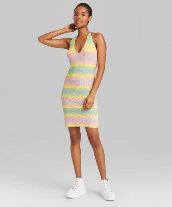 A model wearing a stylish space-dye sleeveless sweater dress.