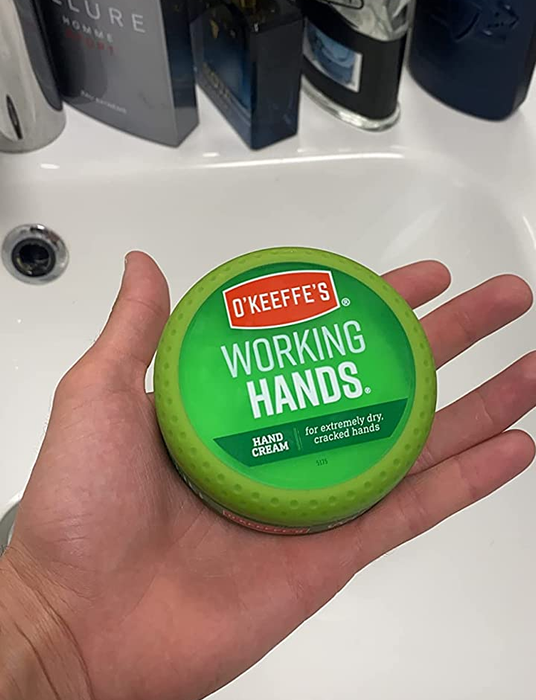 Reviewer holding a jar of O'Keeffe's Working Hands Hand Cream