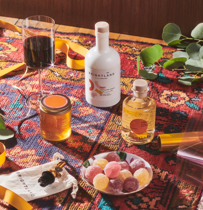 The Luminous Capsule placed next to wine and snacks