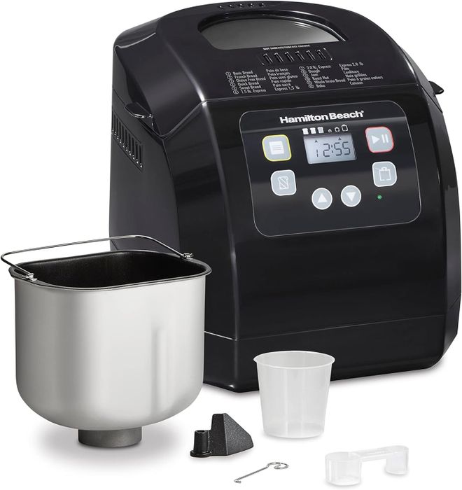 The bread maker sitting next to the included items.