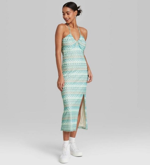 A model is showcasing an aqua blue crochet slip dress.