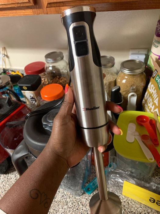 A reviewer showcasing the stainless steel mixer.