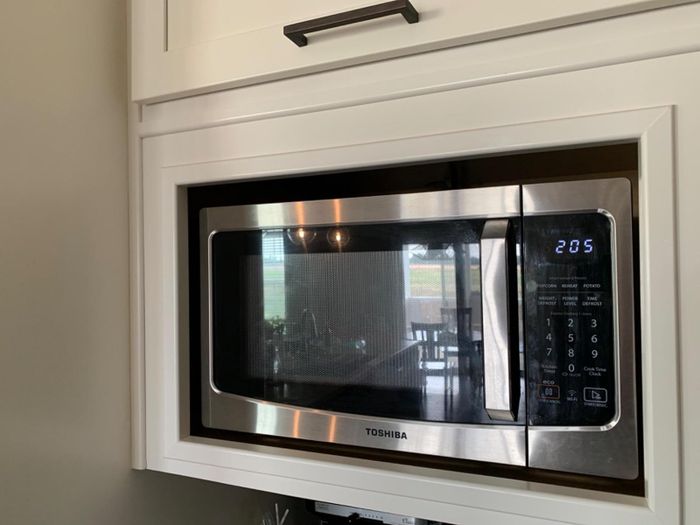 A reviewer's microwave placed in their kitchen space.
