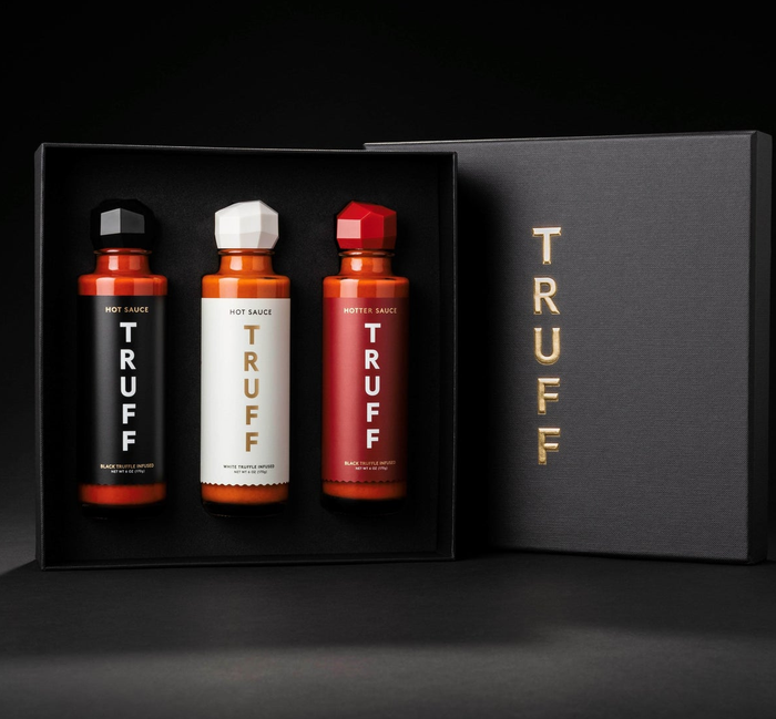 Three bottles of Truff hot sauce beautifully packaged in a gift box
