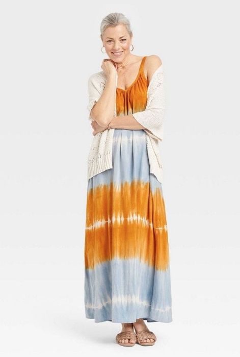 A model showcasing a sleeveless tie-dye dress