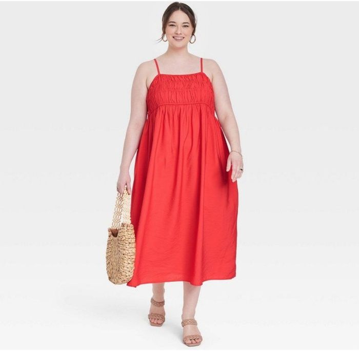 A model in a red spaghetti strap dress