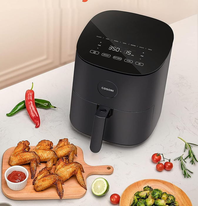 The black air fryer sitting on a kitchen countertop