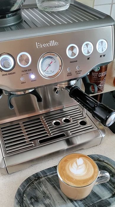 A reviewer shows off their freshly made espresso, showcasing the impressive result from the machine.