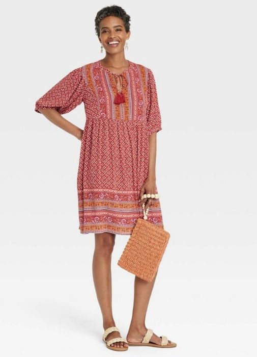 A model wearing a red boho tassel dress