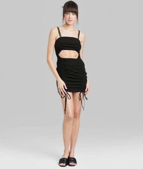 A model showcasing a black sleeveless cutout dress.