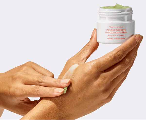 A GIF showing a model massaging the moisturizer into their hand