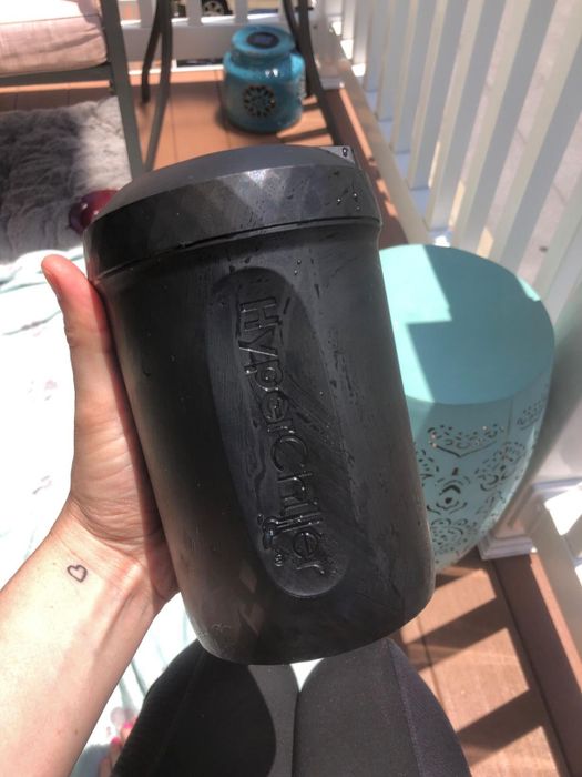 A reviewer holding up the frozen black canister.