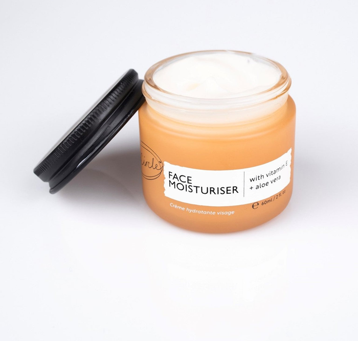 The vibrant orange jar of moisturizer