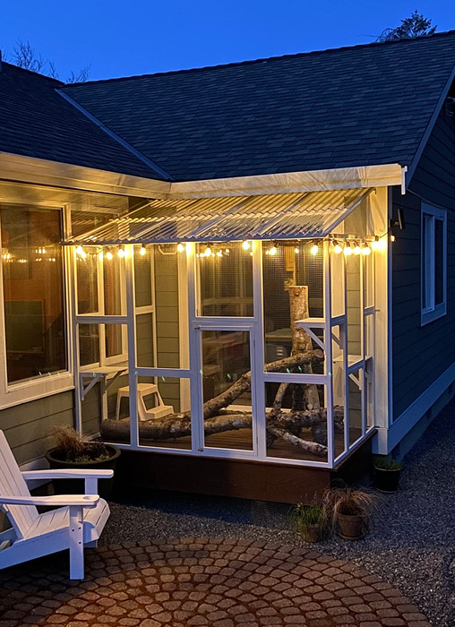 The white catio illuminated at night, glowing softly