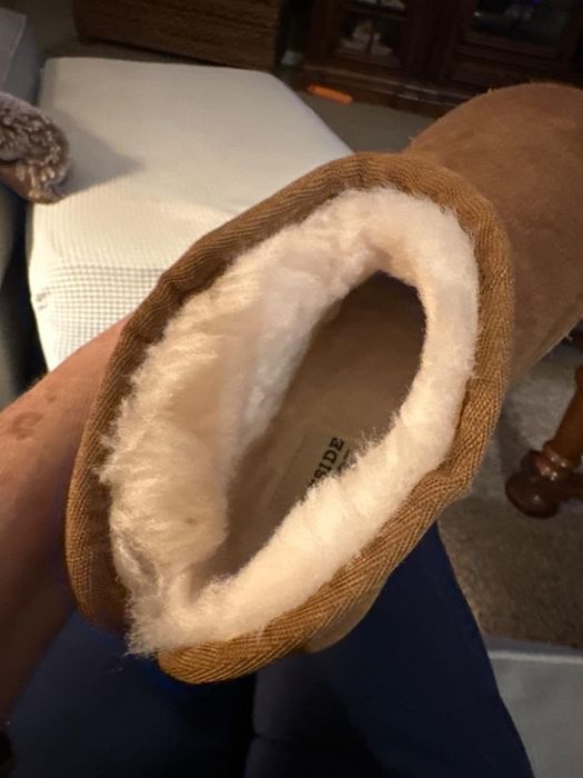 A close-up view inside the faux shearling boots, highlighting the plush lining and cozy interior.