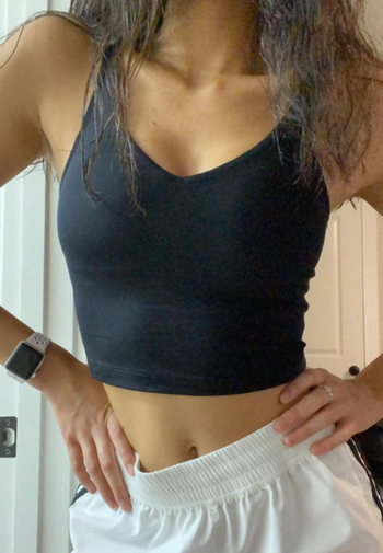 A reviewer models the black version of the outfit.