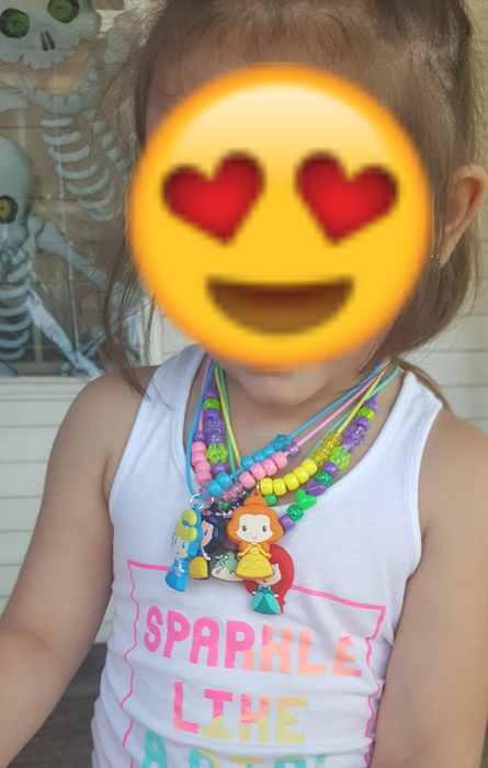 a reviewer’s child sporting several necklaces crafted from the set