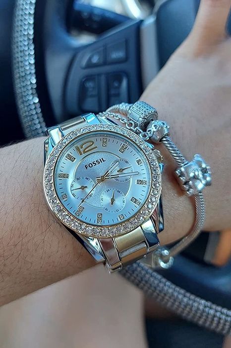 A reviewer models the two-tone gold and silver watch, showcasing its elegant design.