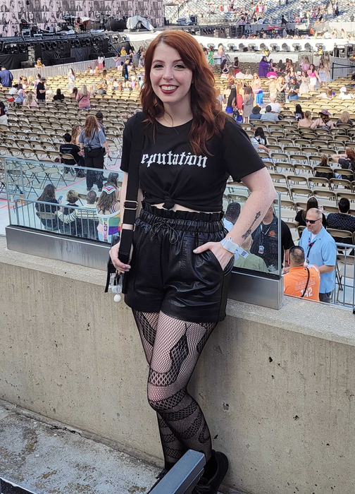 An editor sports the black leather shorts at the Eras tour.