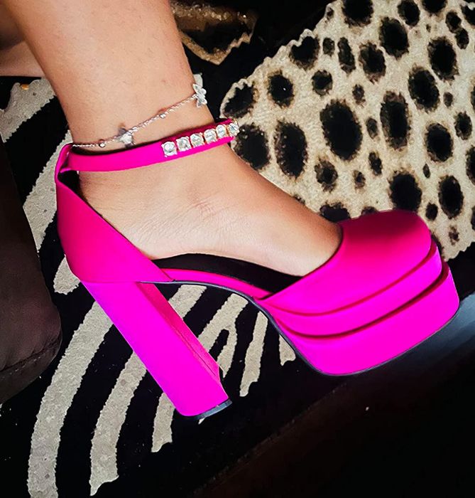 A closeup shot of a reviewer wearing pink heels.