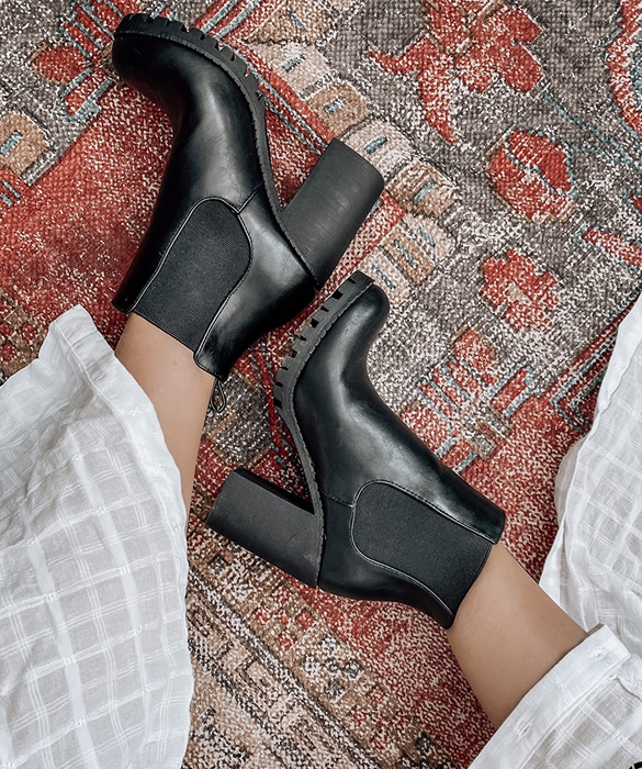 Overhead view of the reviewer's feet wearing black boots