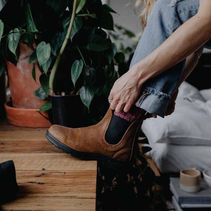A model is seen wearing the brown and black boots.