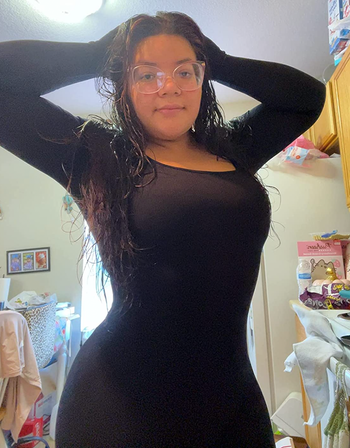 Image of the reviewer showcasing the top portion of the bodysuit with a square neckline.