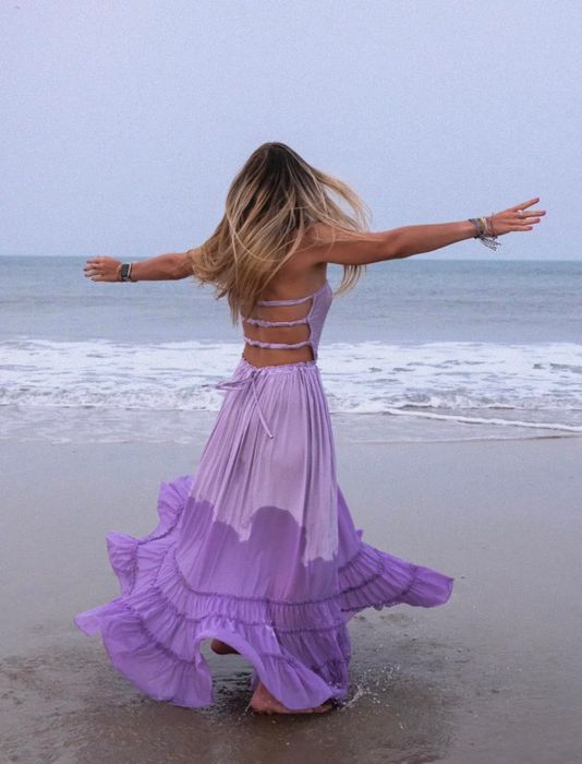 A customer twirling in the purple dress
