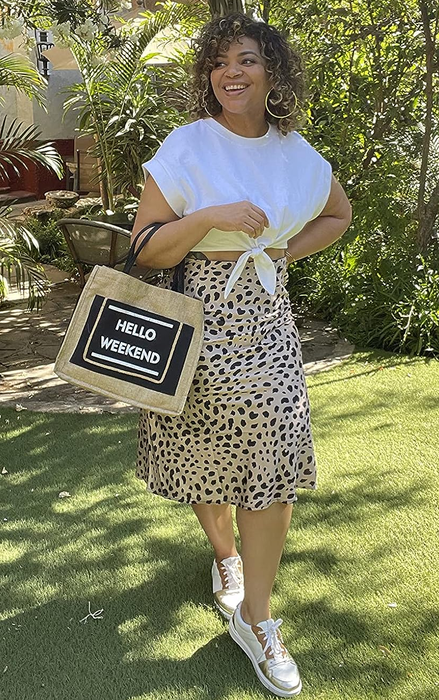 A reviewer styles the leopard skirt with a white tee and sneakers.