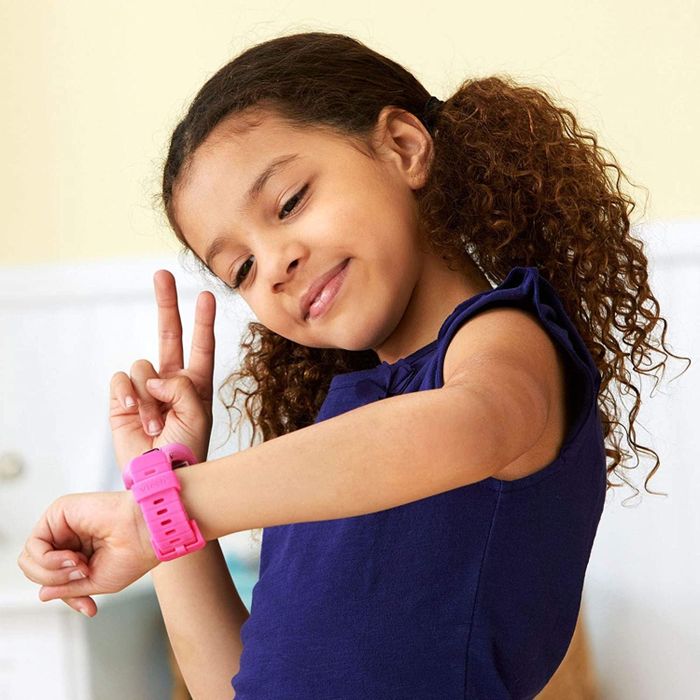 A model smiling while snapping a selfie with the smartwatch