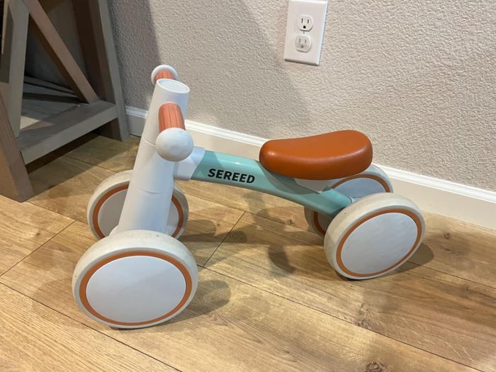 Toddler riding their balance bike with enthusiasm