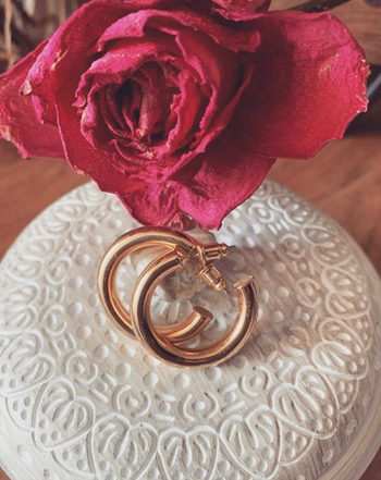 A close-up of earrings displayed on a table.