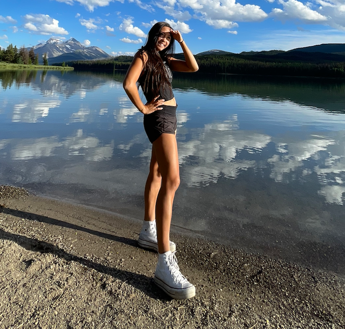 A Mytour writer is pictured wearing the white Converse sneakers.