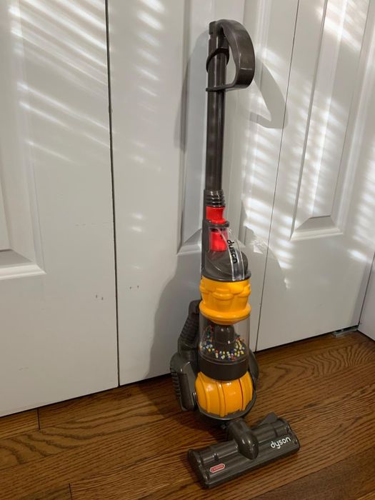 A reviewer’s image showcasing the mini Dyson vacuum in action