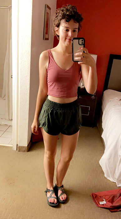 A reviewer is seen wearing the green running shorts.