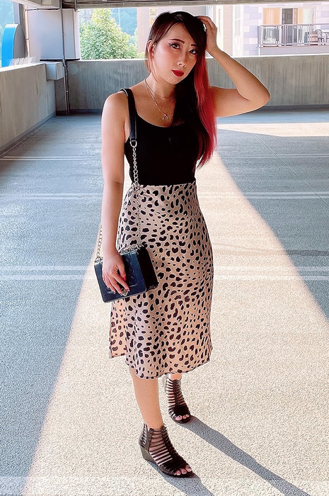 A reviewer models the leopard print skirt.
