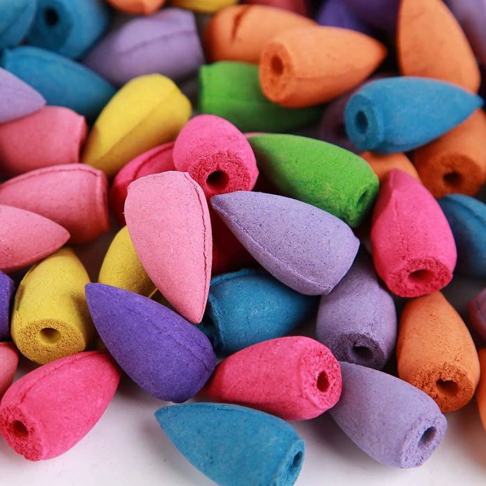 A pile of colorful rainbow incense cones.