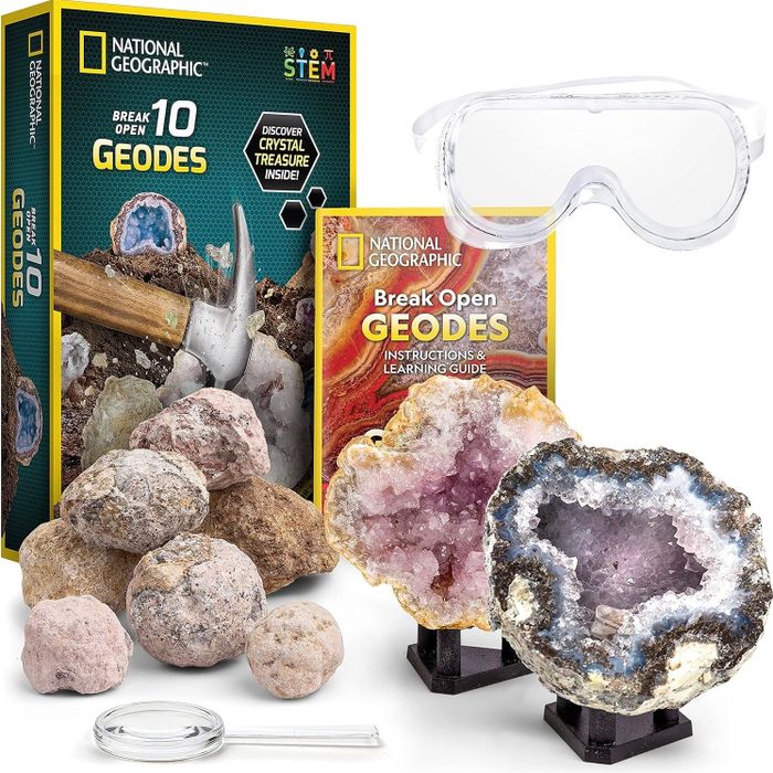 Geode discovery kit featuring rocks, safety goggles, a magnifying glass, and a detailed instruction guide to help unearth crystals inside.
