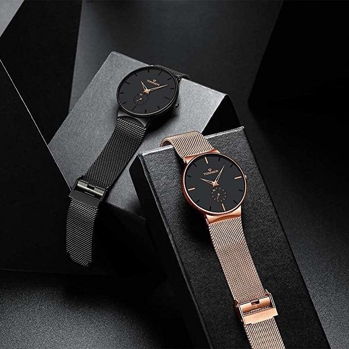 The black and gold watch presented on a display stand