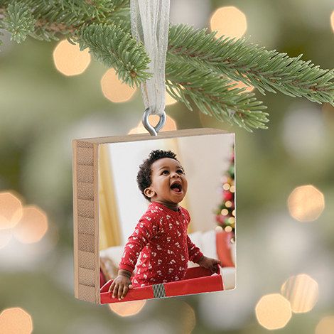 A bamboo ornament block featuring a photo of a child