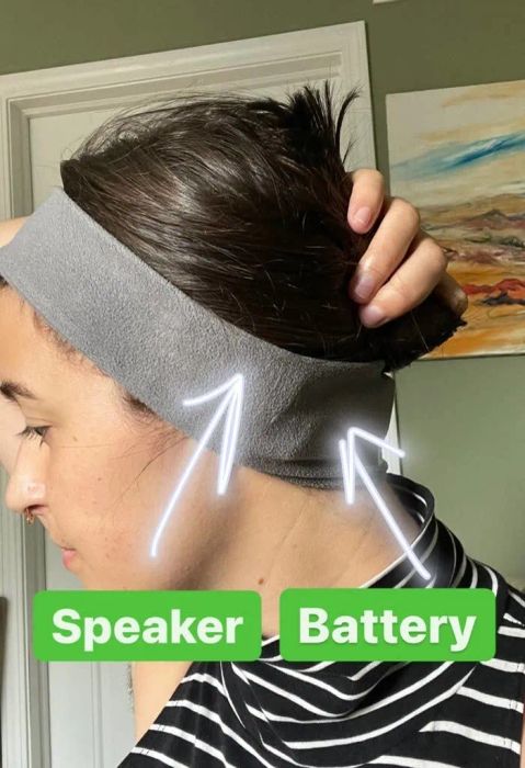 Mytour writer Rachel modeling a headband labeled 'speaker' and 'battery', with arrows pointing to the corresponding features.