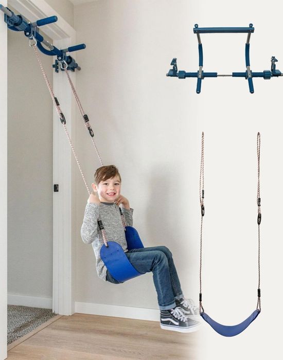 A child swinging on an indoor swing set with a doorway pull-up bar, demonstrating home gym equipment designed for kids