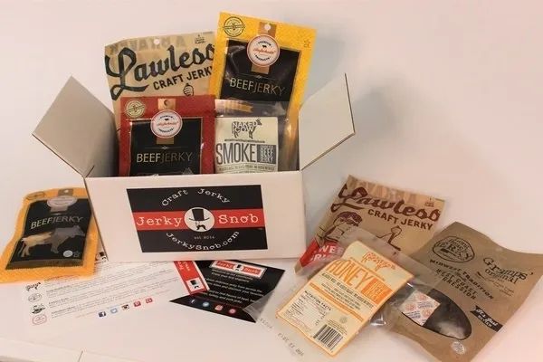 A variety of jerky bags spilling out of a box.
