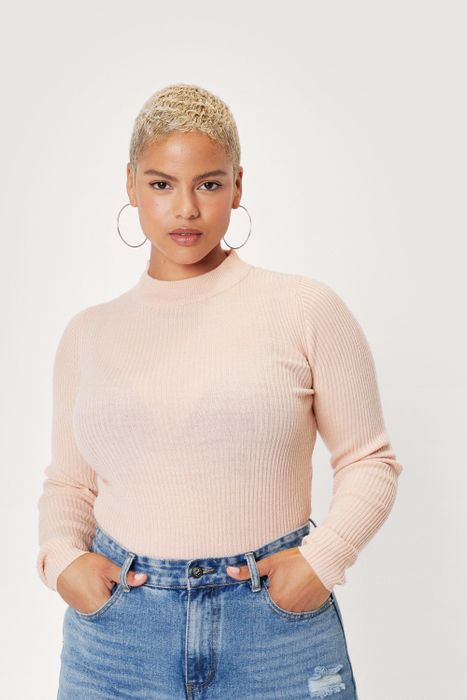 A model wearing a beige sweater.